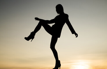 Fototapeta na wymiar Get up and get moving. Dance girl. Girl silhouette on evening sky. Female performer