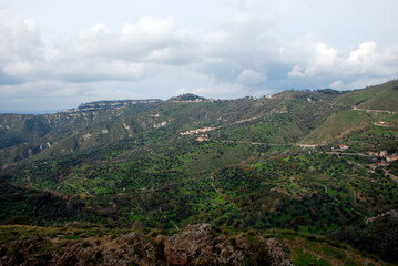 Fototapeta na wymiar Green panorama of the mountain above Reggio Calabria