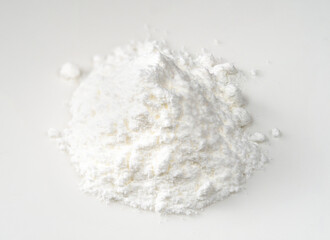 handful of baking powder closeup on white
