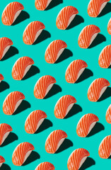 Pattern of nigiri with salmon isolated on turquoise background