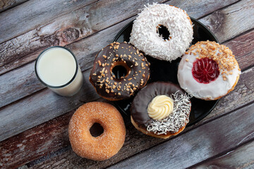 donuts and a glass of milk on the table, doughnuts as dessert, and snack concepts