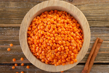 A top down view of a small condiment bowl full of red lentils.