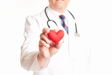 Doctor holding a red heart in his hand. Heart checkup. Health concept
