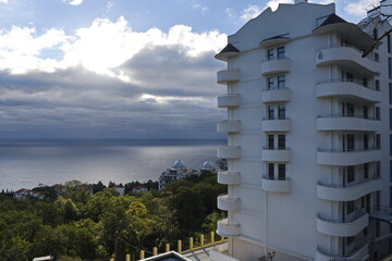 Yalta, Crimea - 10.16.2015 : Apartment building on the shore, against the background of the Black Sea