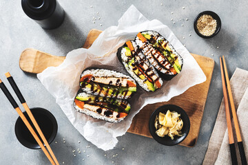 onigirazu sushi sandwich with vegan tofu filling marinated with soy sauce, sweet potatoes and avocado - obrazy, fototapety, plakaty