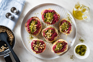 vegan beetroot and pistachio bruschetta with pine nuts on the table