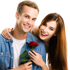 Portrait of happy smiling hugging couple with flower, close to each other. Caucasian models in...