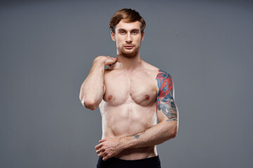 Fototapeta na wymiar sexy guy tattooed athlete bodybuilder fitness muscular torso