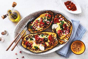baked eggplant with cashew and turmeric sauce, baked bell pepper sauce, pine nuts and yogurt. vegan...