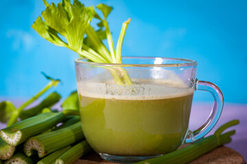 Healthy Celery diet for the treatment of incurable mysterious diseases. Fresh celery juice squeezed out on a juicer.drink, vegetable juice, studio shot