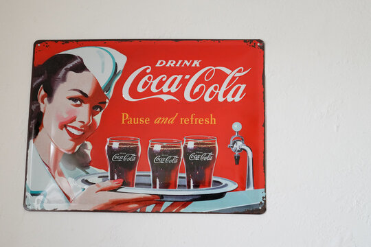 Coca Cola pinup vintage plate advertisement sign logo and brand text coffee store cafe carbonated soft drink produced refreshment