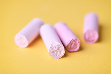 Soft pastels on yellow background. Close up. 