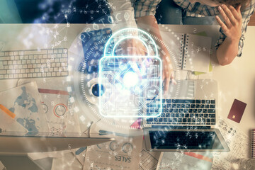Double exposure of man and woman working together and lock hologram drawing. Security concept....