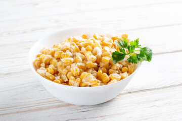 Frozen corn in a plate on white table. Frozen food