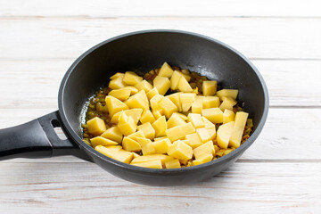 Fried potatoes with spices in a pan. Ingredients for cooking Gobi Aloo cauliflower and potatoes, horizontal