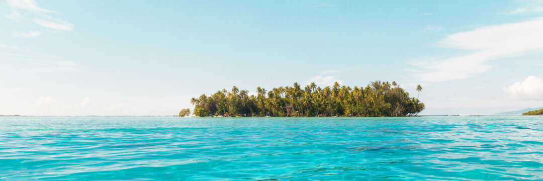 Beach paradise travel vacation view of tropical motu island idyllic crystalline turquoise ocean in Rangiroa atoll, Tuamotu islands, French Polynesia. Tahiti honeymoon destination panoramic banner.