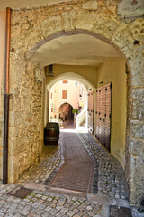 Fototapeta na wymiar Sonnino, Italy, 05/10 / 2021. A street between old medieval stone buildings of a historic town in Lazio region, Italy.
