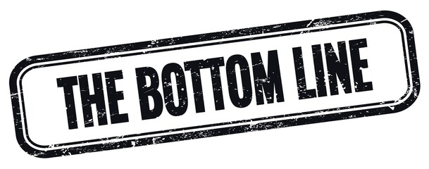 THE BOTTOM LINE text on black grungy vintage stamp.
