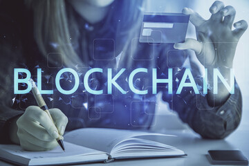 Fototapeta premium Multi exposure of woman on-line shopping holding a credit card and crypto theme drawing. Blockchain E-commerce concept.