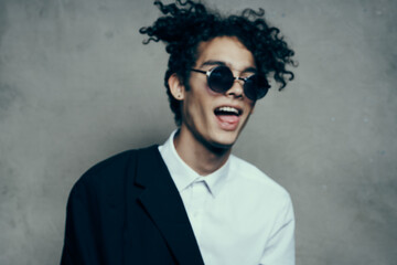 handsome guy model in shirt and glasses jacket on shoulder 