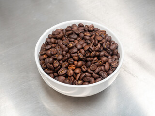 Roasted coffee beans on stainless steel top table