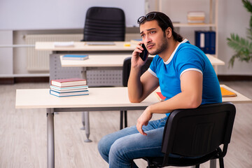 Young male student in the classroom