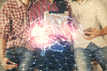 Double exposure of man and woman working together holding and using a mobile device and brain...