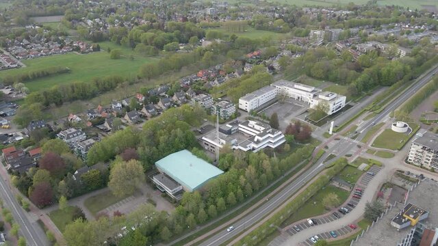 Aerial overview of long road running through small suburban town
