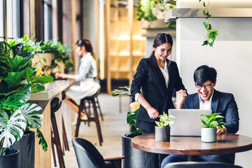 Group of professional multiethnic teamwork business discussing meeting strategy sharing idea with new startup project.Creative business people working with laptop computer in green plant terrace