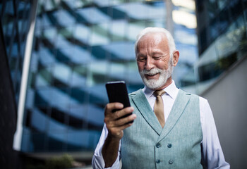 Senior business man using smart phone.