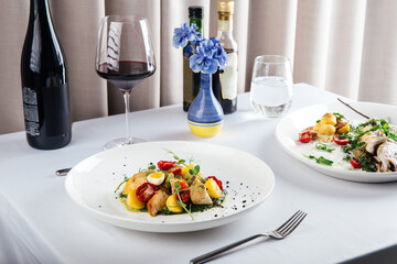 Mediterranean restaurant dishes on the served table with red wine