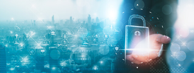 Blurred-businessman holding padlock protect icon,and virtual screen interface,protecting data personal and network information,cyber security technology with data protection privacy concept