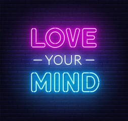 Love Your Mind neon lettering on brick wall background.
