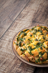 Delicious hearty bread for a large company, a whole loaf of bread stuffed with cheese and sausage and baked in the oven