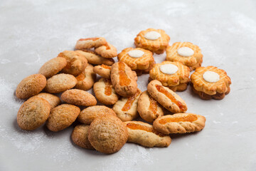 Heap of different small cookies on the grey background