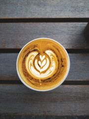 a cup of latte art coffee on wooden background                                                                                                                                                          