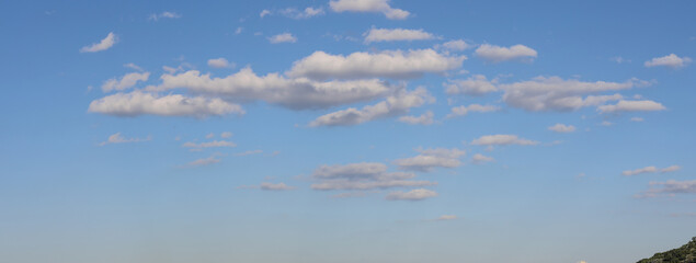 clouds in the sky. Beautiful cloudscape over the river on a sunny day. Scenic morning blue sky with little fluffy clouds. 