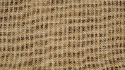 Hessian sackcloth burlap woven texture background, Cotton woven fabric close up with flecks of varying colors of beige and brown, with copy space for text decoration.