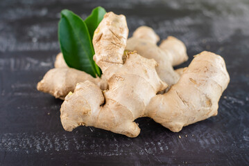 fresh ginger root on rustic board blackground