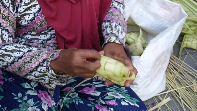 Process of making ketupat, special dish served at Ied Fitr celebration in Indonesia