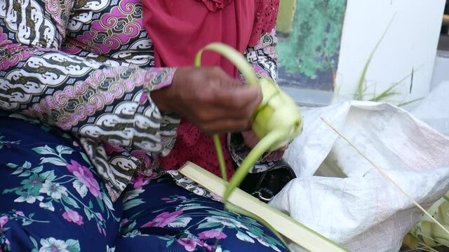 Process of making ketupat, special dish served at Ied Fitr celebration in Indonesia