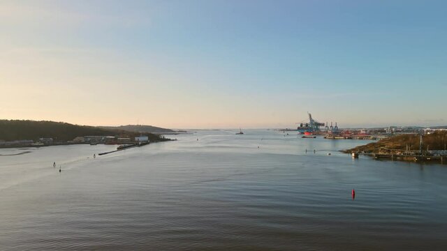 Sea Marks On Gota Alv River With Freight Ship On Harbour At Sunrise In Gothenburg, Sweden. - aerial