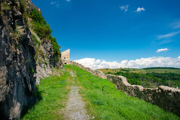 green trees and blue sky in a beautiful visit to the ancient stone fortress - 433395509