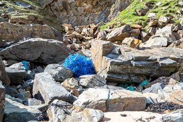 Blue packing band Lying on the pebble beach in Ireland