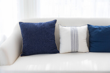 blue and white stripe pillow on white sofa couch. living room interior decoration.