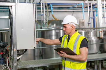 Machine engineers inspect machines and sterilizers in food factories or factory drinking water plants. Machine maintenance