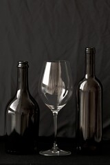 wine bottle and glass in black background