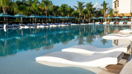 Empty sunbeds in a  pool. Copy space