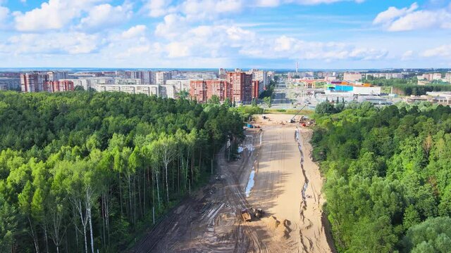 Construction of a new highway. Sand embankment preparation by road machinery