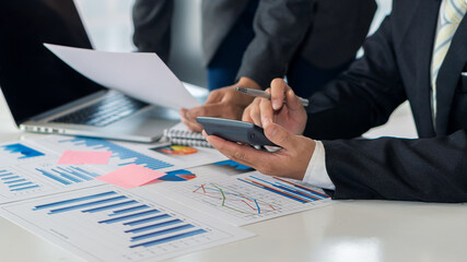 Business people who do business in finance and calculate, analyze, graph the cost of investment. Desk-top tariff system with laptop and calculator with documents